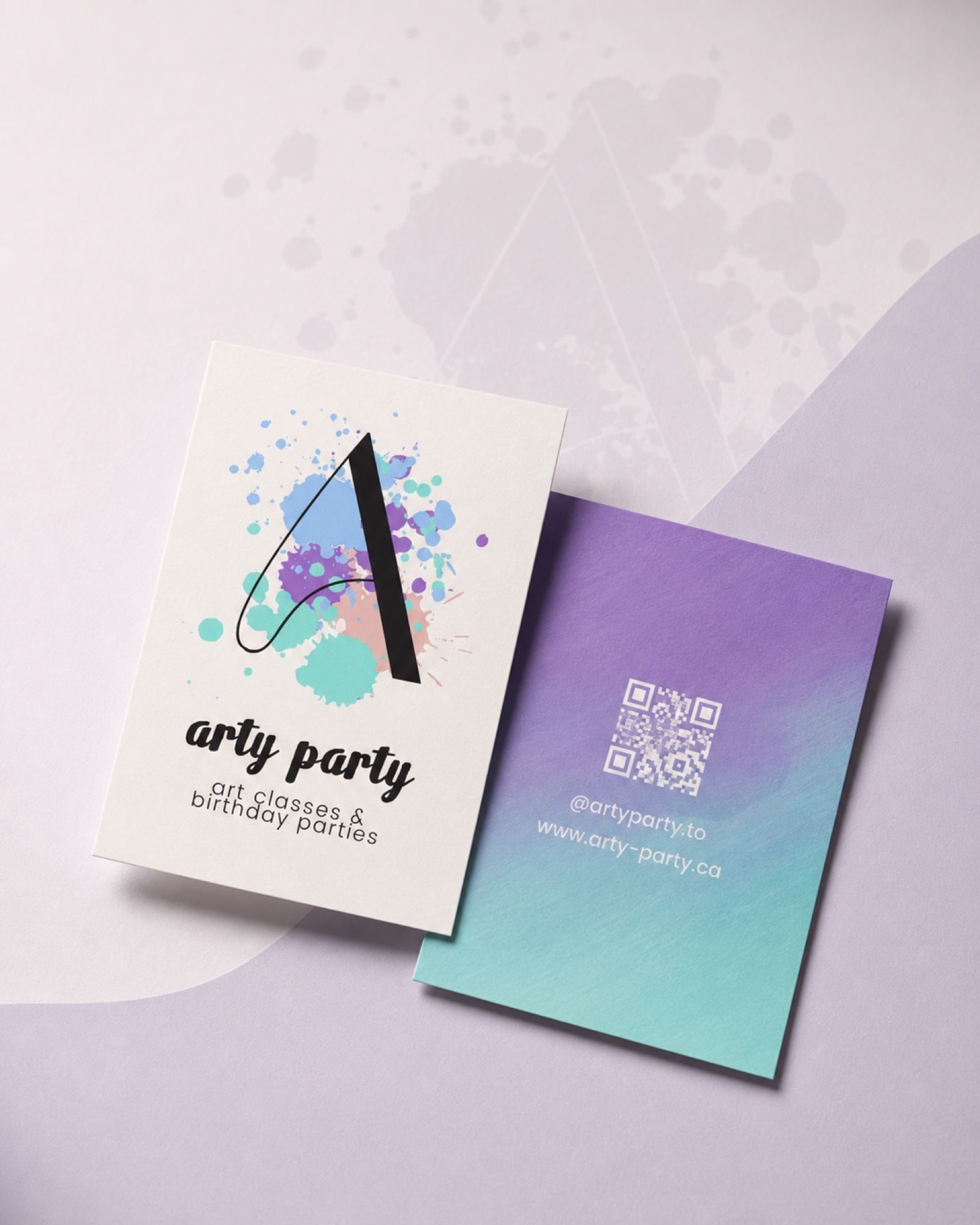 Front and back of the card together — the gradient reverse carries just the QR code, the Instagram handle, and the site address.