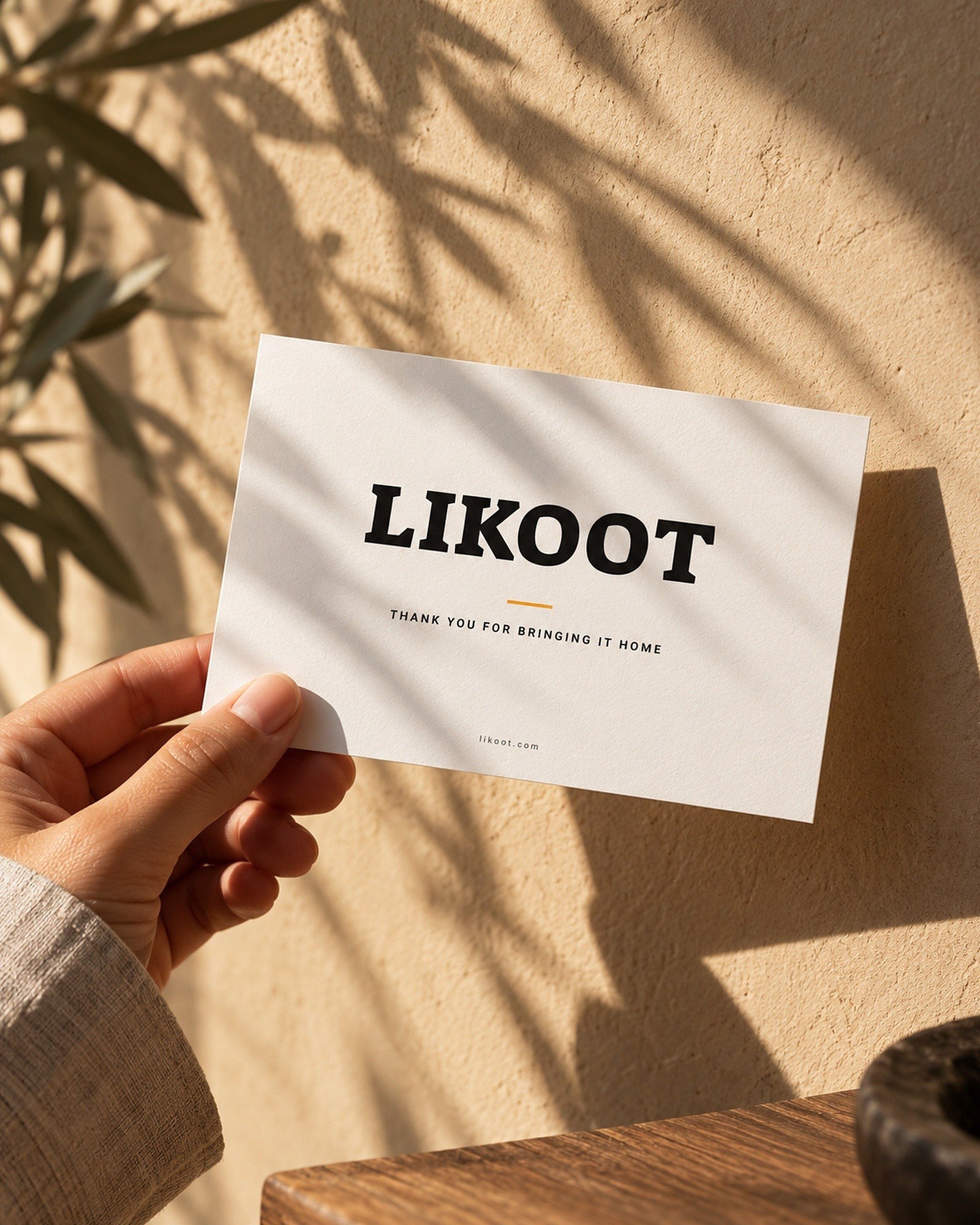 The white Likoot thank-you card in late sun.