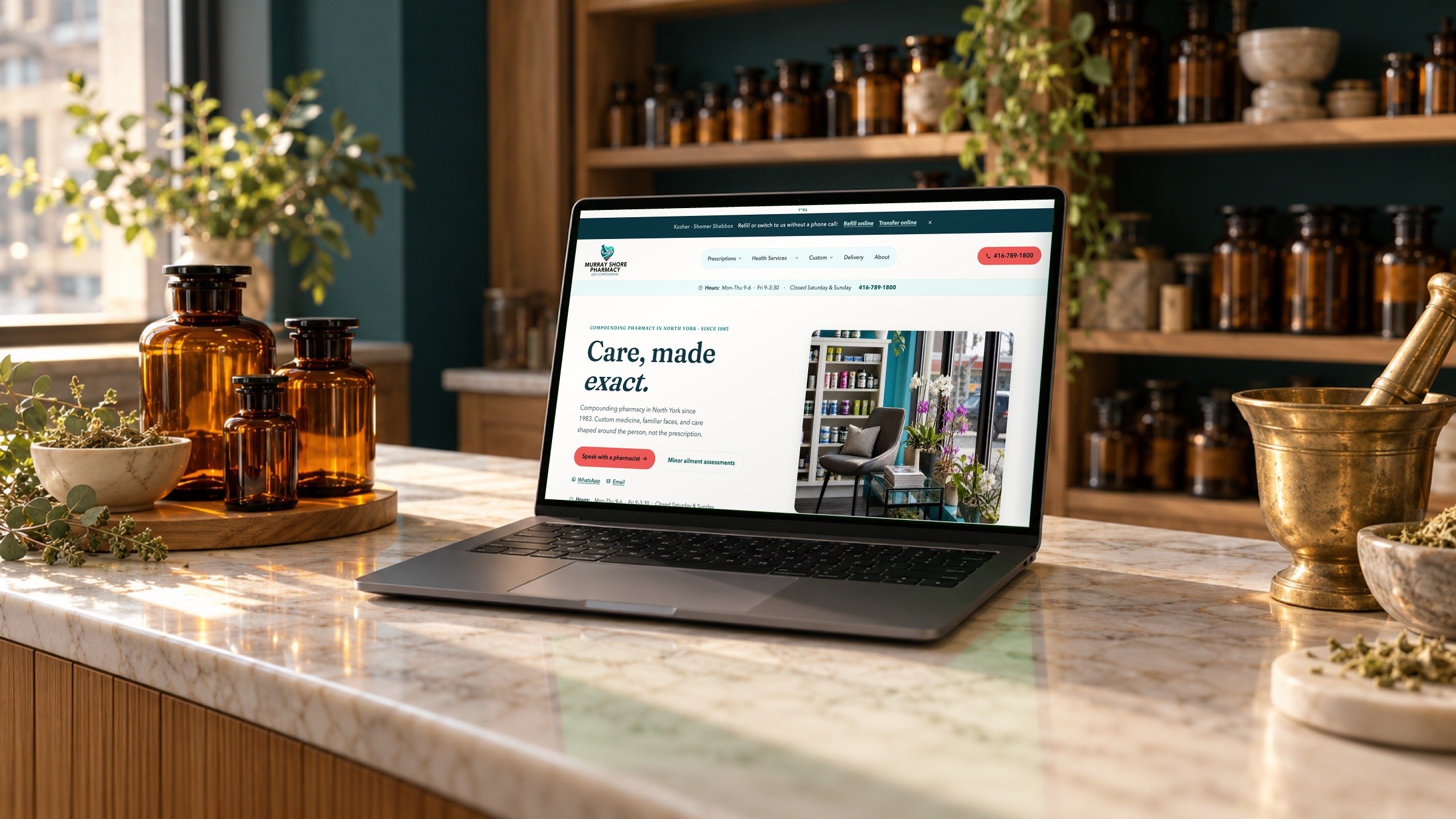 The murrayshore.com home page on a laptop on a marble pharmacy counter.