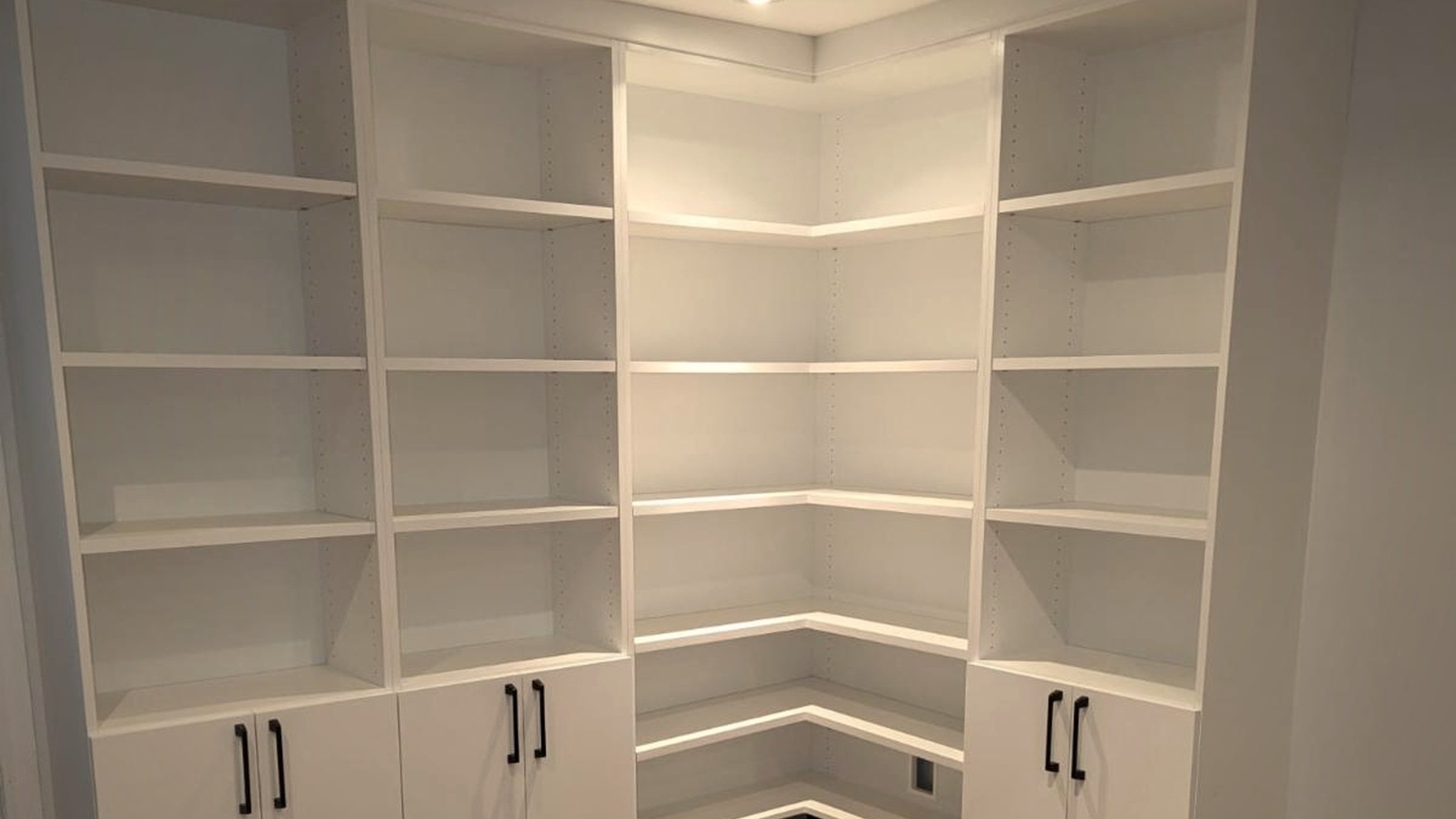 A finished corner unit, straight off the job site — shelving and cabinetry built into a room that used to be dead space.