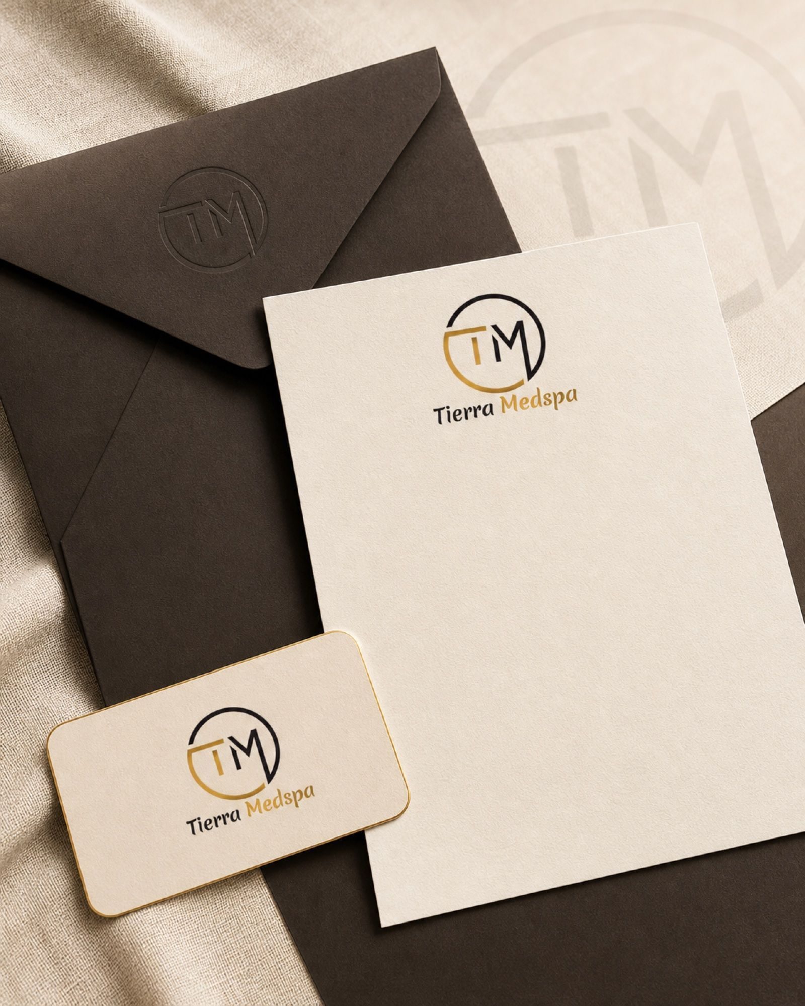Envelope, letterhead, and card in one lockup — the paper system that leaves with every client.