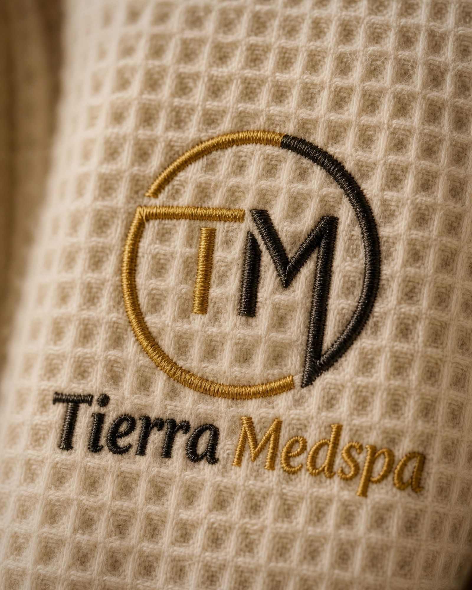A closer look at the stitching — gold thread on waffle cotton.